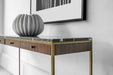 Chic console table with a black marble top, walnut wood drawers, and a brass-finished frame, perfect for luxurious entryways, placed in a living view 2.